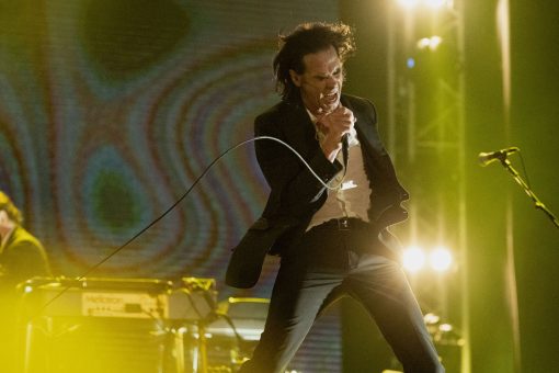Musician Nick Cave singing on stage