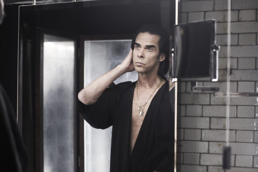 A photo of Nick Cave looking to himself im the mirror