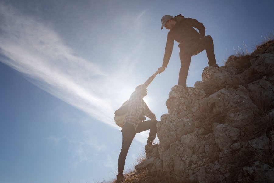 Two men climbing a hill, concept of discovery